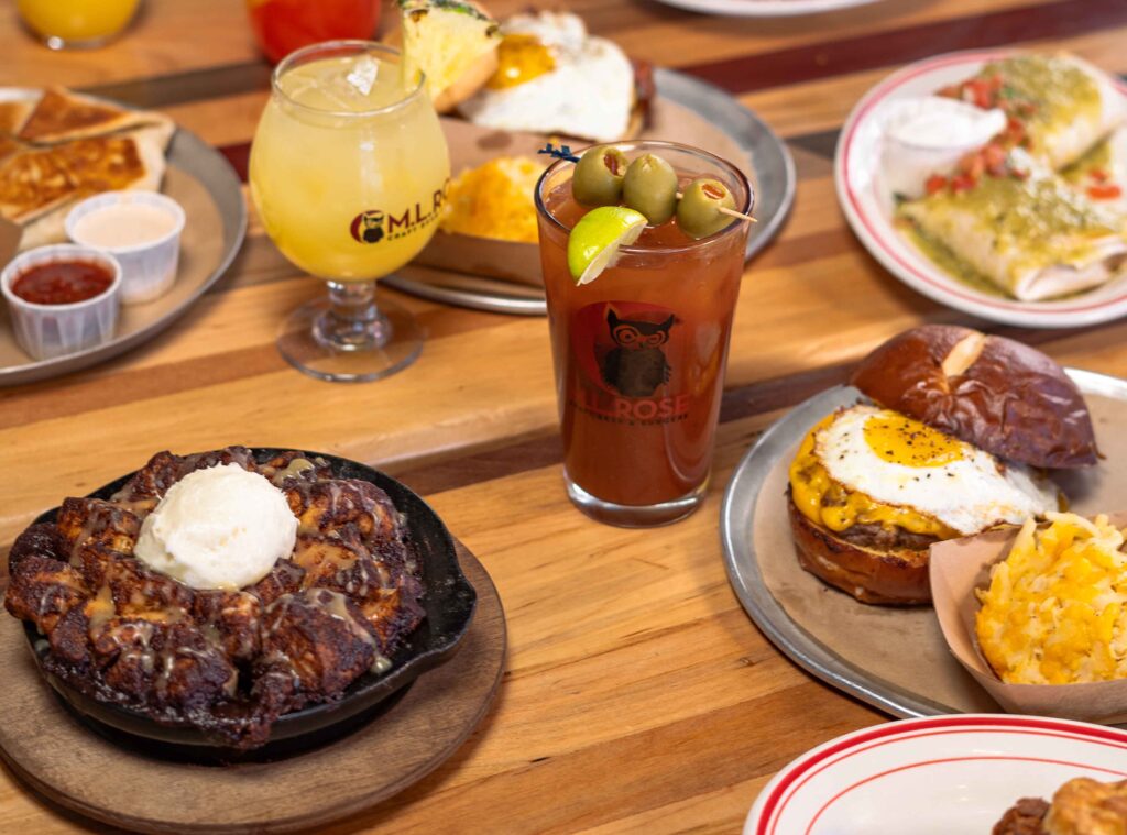 Brunch spread with cocktails and breakfast plates