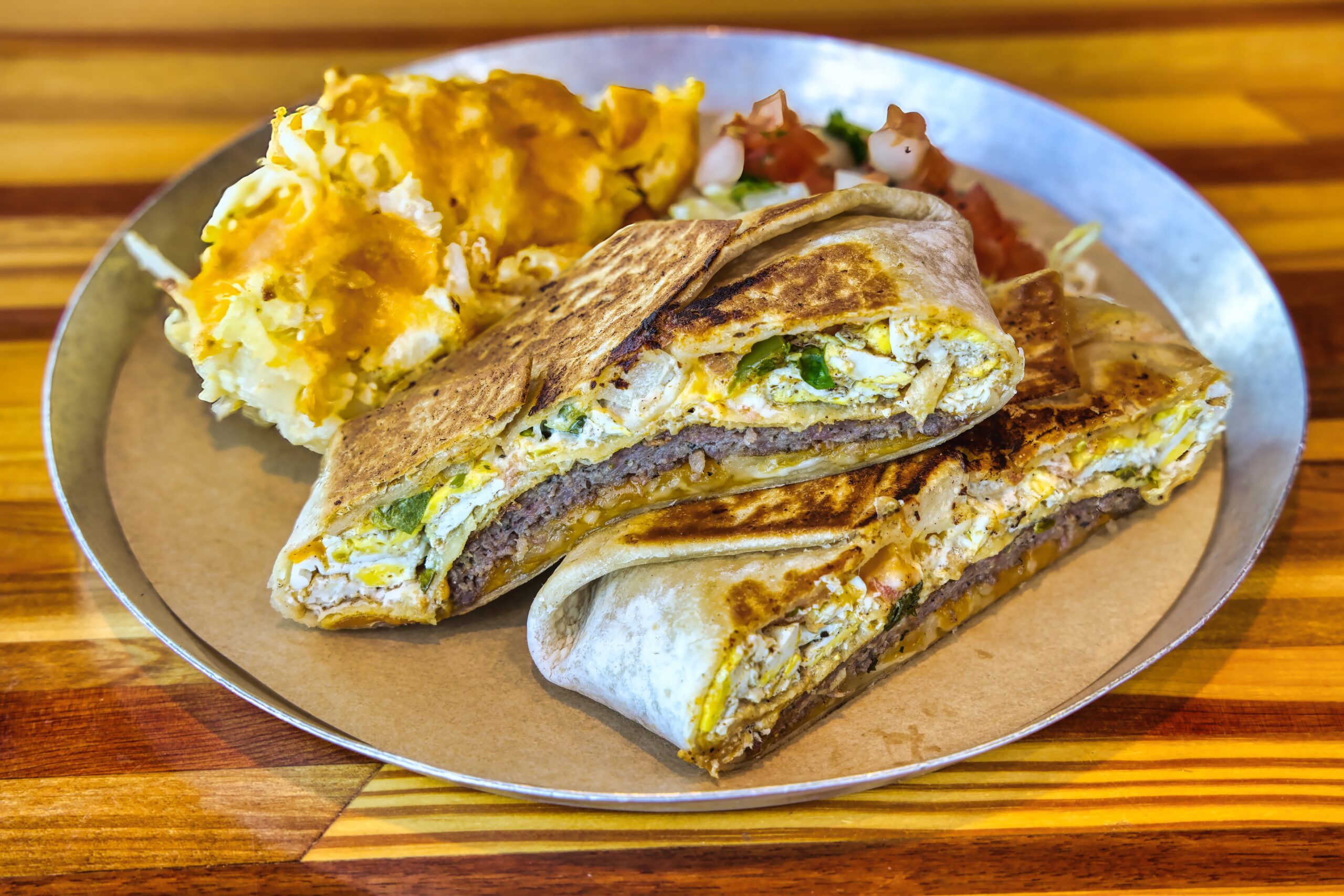 Breakfast wrap sliced open with eggs and sausage