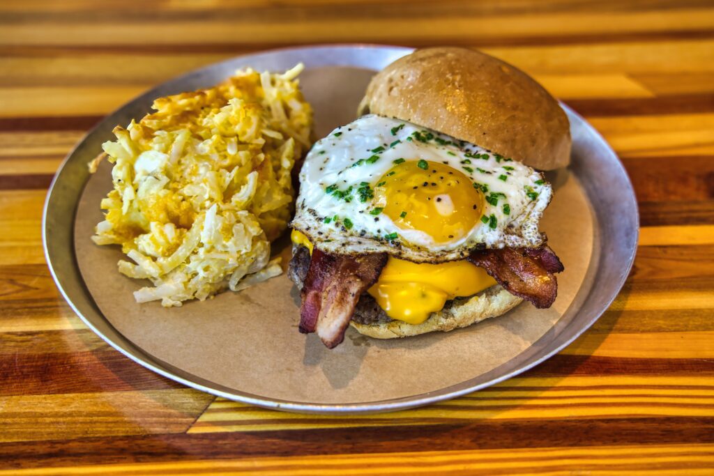 Breakfast sandwich with egg and bacon on bun