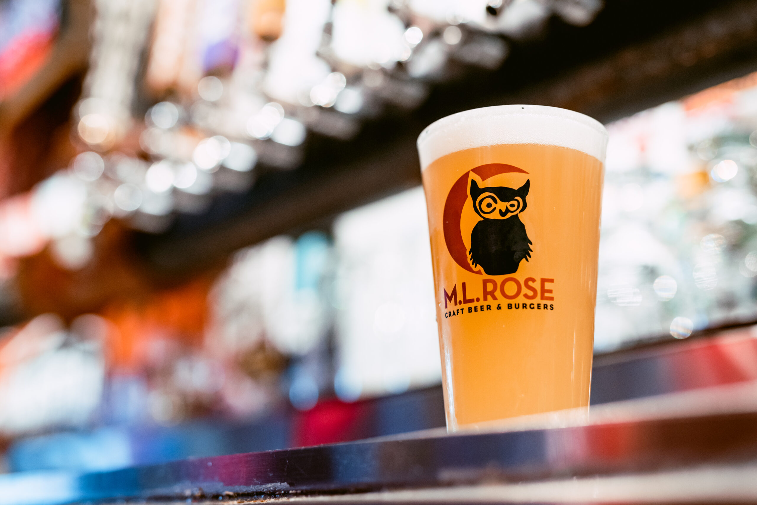 M.L.Rose branded pint glass filled with beer